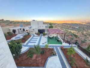an aerial view of a building in the desert at Ayla Shalet Villa in Al Kufayr