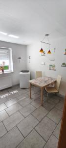 a dining room with a table and two chairs at Ferienhaus Margarete in Dankerode