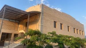 a building with a tree in front of it at RUBENYAN GUEST HOUSE in Artashat