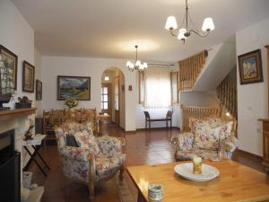 a living room with two chairs and a table at Los Balcones de San Marcos in Galera