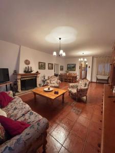 a living room with a couch and a coffee table at Los Balcones de San Marcos in Galera
