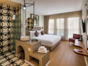 a hotel room with a bed and a fireplace at Margosa Boutique Hotel Tel-Aviv Jaffa in Tel Aviv