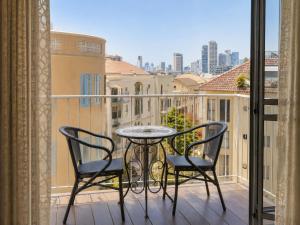 a table and two chairs on a balcony with a view at Margosa Boutique Hotel Tel-Aviv Jaffa in Tel Aviv