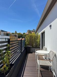 a balcony with tables and chairs on a building at Leiria Design Suites in Leiria