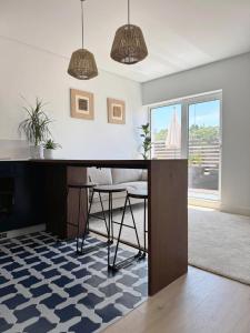 a dining room with a table and chairs and a window at Leiria Design Suites in Leiria