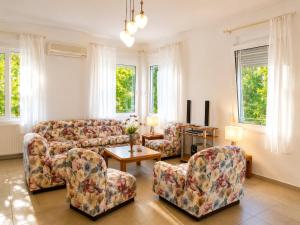 a living room with two couches and a table at Villa Serena in Mytikas +12 photos