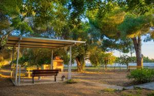 a park with a bench and a playground at Villa Serena in Mytikas