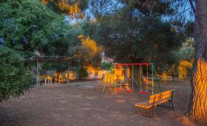 a park with a playground and a swing set at Villa Serena in Mytikas