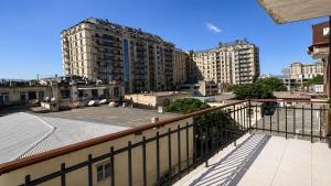 a balcony with a view of a city with tall buildings at Sahil Bay Hostel in Baku