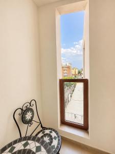 a mirror in a room with a bench and a window at AM Sea Studios in Ravda