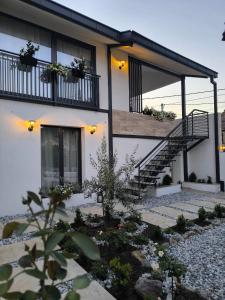 a house with a staircase in front of it at Kostadinov Residence in Demir Kapija