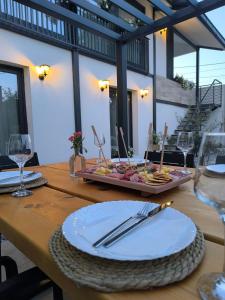 a wooden table with a tray of food on it at Kostadinov Residence in Demir Kapija