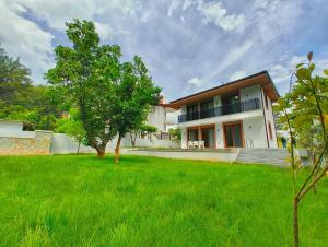 a house with a green lawn in front of it at Villa Musa in Marmaris