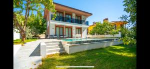 a house with a swimming pool in the yard at Villa Musa in Marmaris