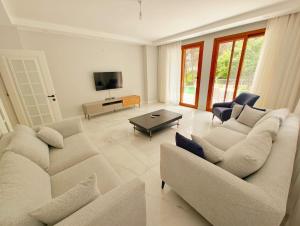 a living room with two couches and a tv at Villa Musa in Marmaris