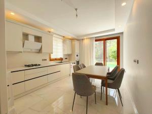 a kitchen with a dining room table and chairs at Villa Musa in Marmaris