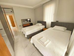 a hotel room with two beds and a mirror at Villa Musa in Marmaris +20 photos