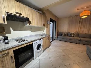 a kitchen with a washer and dryer in a room at Smir Park apartamento in Marina Smir