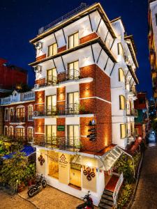 a tall white building with lights on it at Beautiful Kathmandu Hotel in Kathmandu