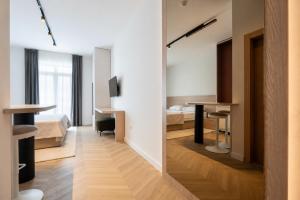 a room with two beds and a desk and a mirror at Villa Sunce Beachfront in Podgora