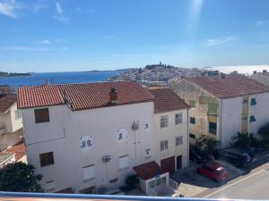 a view of a city with buildings and the ocean at Guest House Lav in Primošten