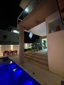 a house with a swimming pool at night at Casa com piscima e área goutmet in Camaçari