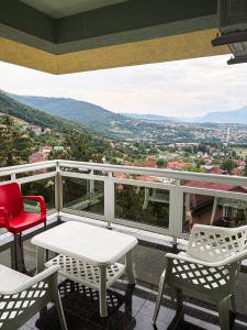 a balcony with a table and chairs and a view at Harmony Rooms & Apartments in Vogošća
