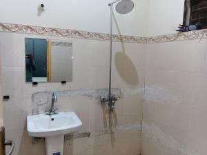 a bathroom with a sink and a shower at Crown Valley Guest House in Lahore
