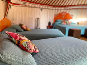 a bedroom with two beds with pillows on it at La Dorépontaise YOURTE MONGOLE in Pondaurat