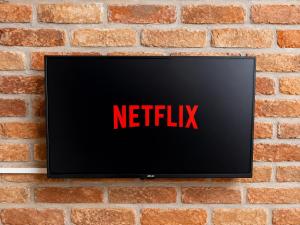 a television on a brick wall with the netflix sign at al home in Crema