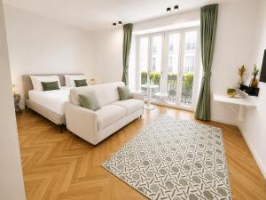 a living room with a white couch and a rug at B and G San Babila- Luxury in the heart of Milano - Design district in Milan