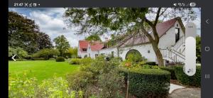 a white house with a green yard in front of it at Villa Hortensia in Meise