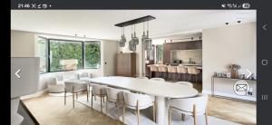 a kitchen and dining room with a white table and chairs at Villa Hortensia in Meise