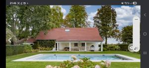 a house with a swimming pool in the yard at Villa Hortensia in Meise +8 photos