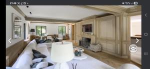 a living room with a white couch and a fireplace at Villa Hortensia in Meise