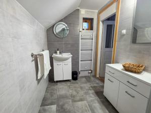 a bathroom with a sink and a mirror at Kuća za odmor Lipa Dora near Plitvice in Donji Babin Potok +49 photos