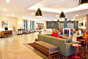 a lobby with couches and chairs in a building at Four Points By Sheraton - Saginaw in Saginaw
