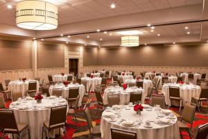 a banquet hall with white tables and chairs at Four Points By Sheraton - Saginaw in Saginaw +45 photos
