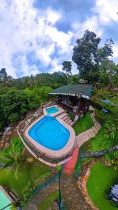 an overhead view of a swimming pool next to a building at Pulangbato Falls Mountain Resort in Dumaguete
