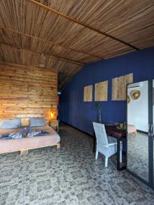 a bedroom with a bed and a desk in a room at Bon Vivant Front de Mer - Ile Rodrigues in Rodrigues Island