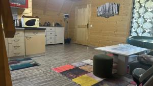 a kitchen with a counter and a table in a room at Wooden Fairytale in Bihać