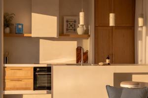 a kitchen with wooden cabinets and a stove top oven at CAPO LEFKADA Villa 97 - Sea View - Two Private Pools in Tsoukalades