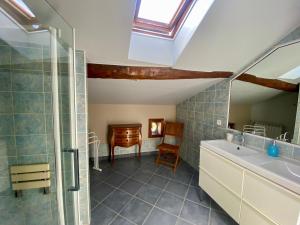 a bathroom with a sink and a shower and a desk at La Dorépontaise CHAMBRE D'HOTES in Pondaurat