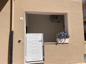 a door to a building with a potted plant at Alessandra guest house in Alghero