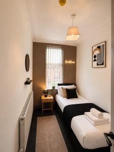 a bedroom with two beds and a window at 6 BR Home Free Parking Sleeps 14 Table Tennis City Centre Pool Table in Central Station