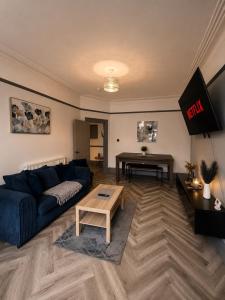 a living room with a couch and a table at 6 BR Home Free Parking Sleeps 14 Table Tennis City Centre Pool Table in Central Station