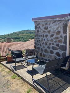 a group of chairs and a table on a patio at La maison D'Orée in Polignac +9 photos