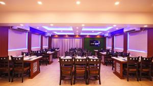a dining room with tables and chairs and purple lighting at ROYAL GITANJALI RESORTS & SPA in Mandarmoni +89 photos