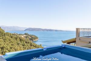 a view of the water from a house with a swimming pool at Kalami Sunlight Villa in Kalami