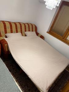 ein Bett in einem Zimmer neben einem Fenster in der Unterkunft Travnik apartment in Travnik + 4 Fotos